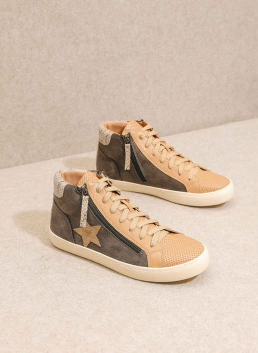 A pair of beige and brown high-top sneakers with a star design on the side, displayed against a neutral background.