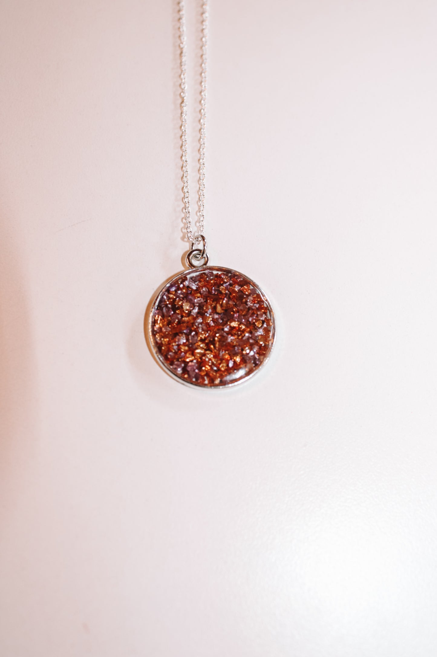 #115 circle necklace with purple and orange sparkle
