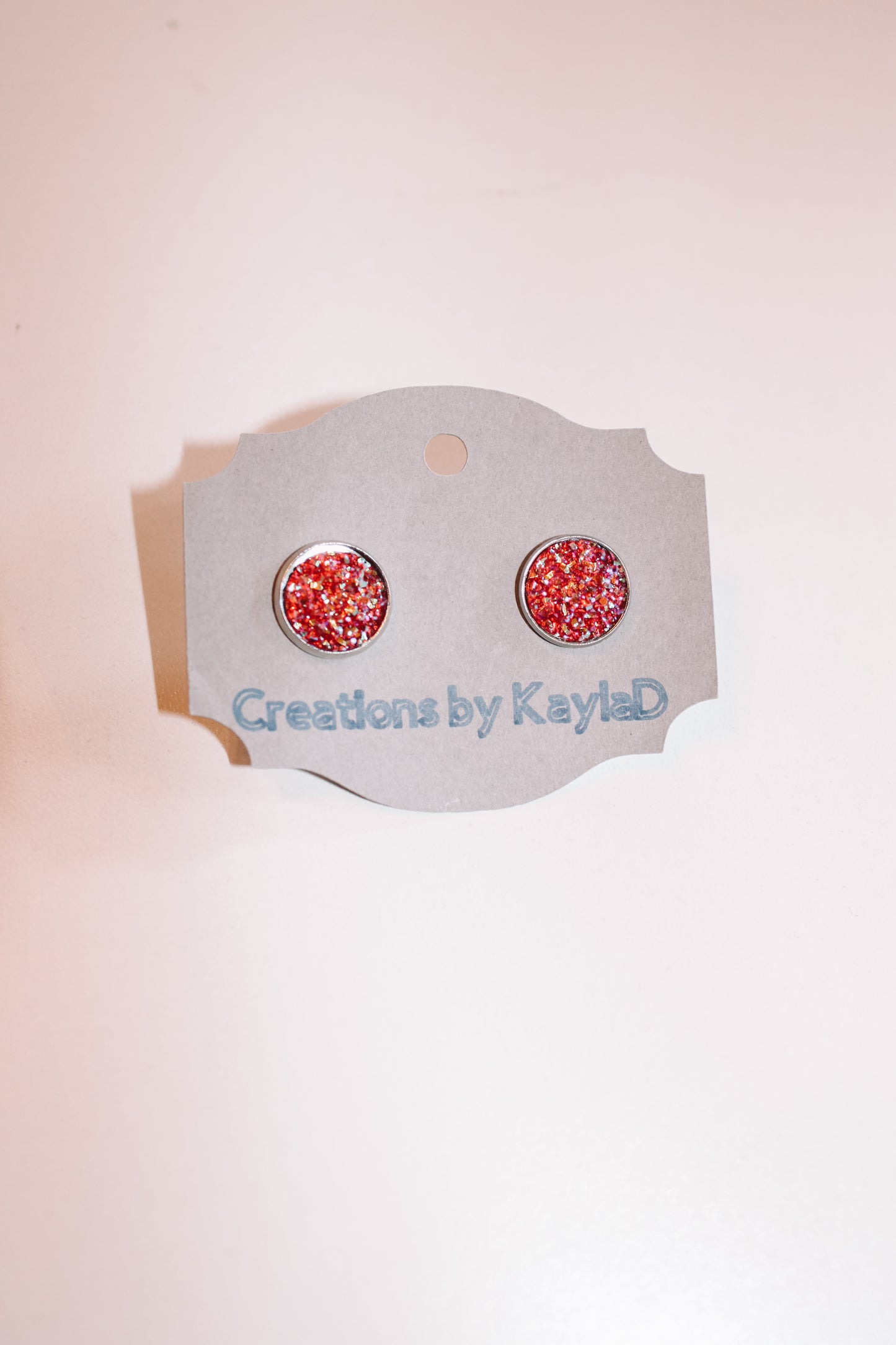 #108 red sparkle studs